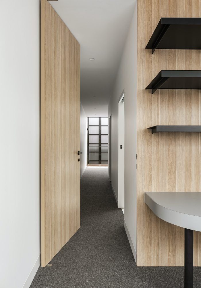 Interior by Peafowl Studio with layered lighting and custom joinery
